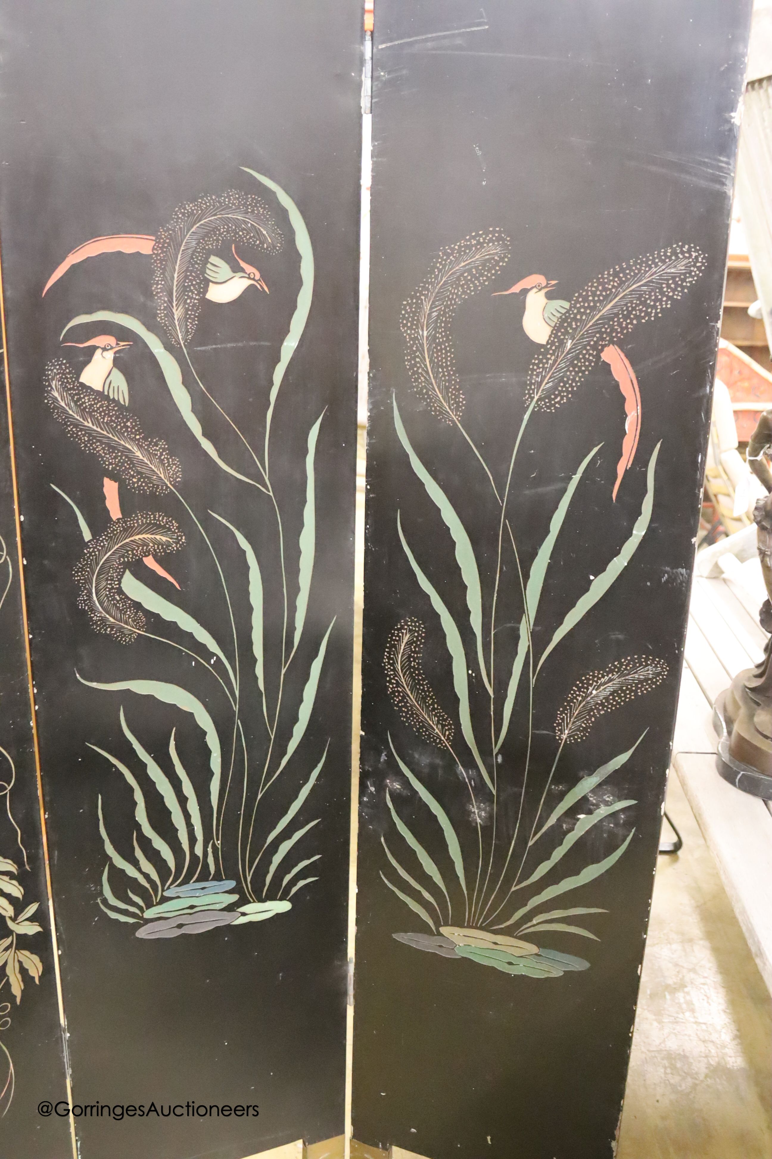 A Chinese ebonised four fold draught screen, painted each side with exotic birds and foliage, each panel width 40cm, height 187cm